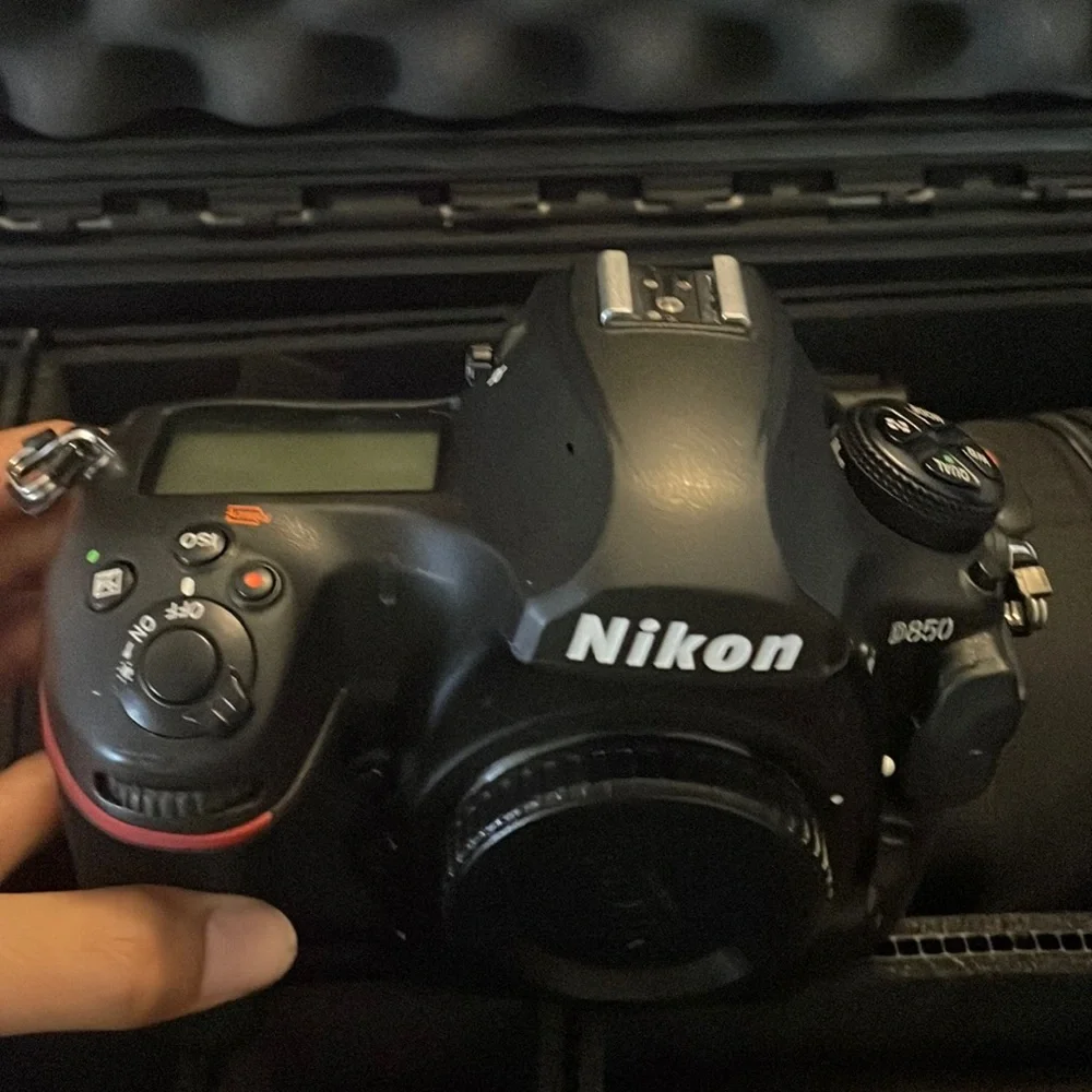 Nikon D850 digital black camera. With battery charger